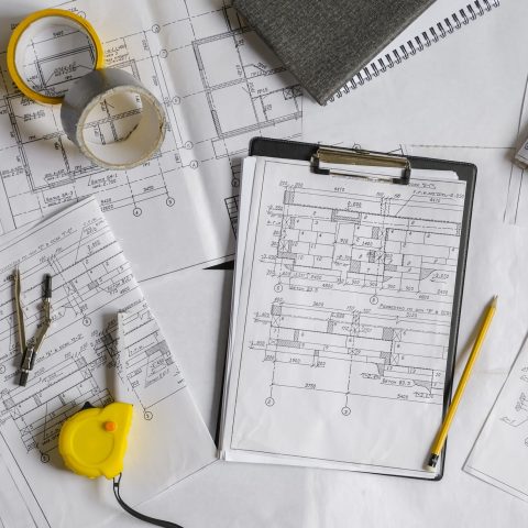 Architect works remotely from home in quarantine, lockdown covid 19 coronavirus. Remote work, stay home, new normality, social distance. Architect design working drawing sketch plans blueprints